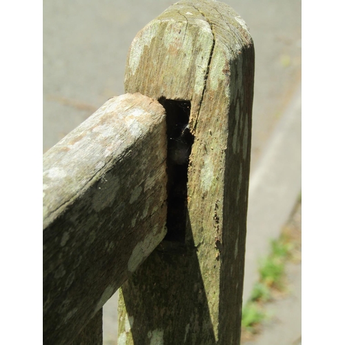 1072 - A large weathered teakwood garden bench with slatted back and seat, 95 x 163.