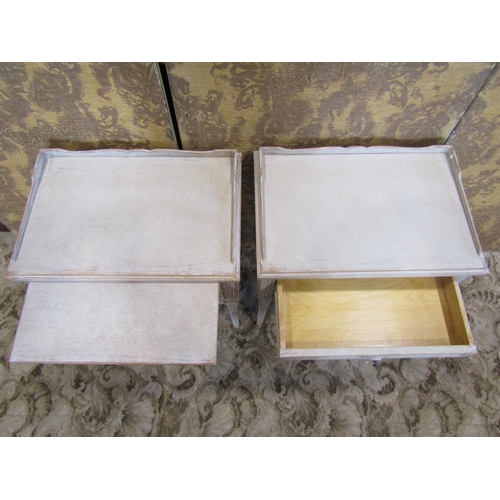 1193 - A pair of painted and dry scrapped low continental bedside cabinets, each with raised gallery over a... 