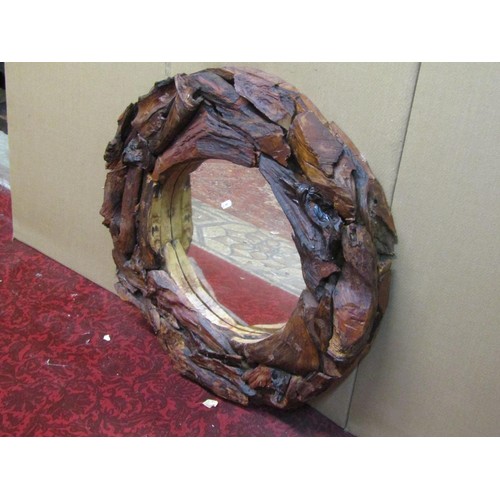 1423 - A rustic timber framed wall mirror of circular form with stained finish, 70 cm diameter.