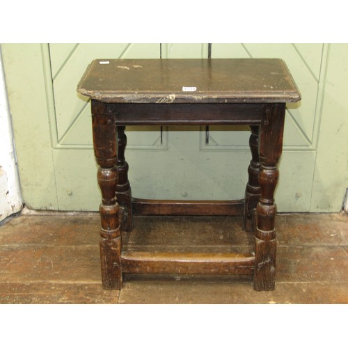 1518 - An early English oak coffin / joint stool, with stepped top over turned supports untied by rail stre... 