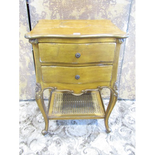 1164 - A french bedside table fitted with twin drawers and bergere caned platform base, with distressed gol... 