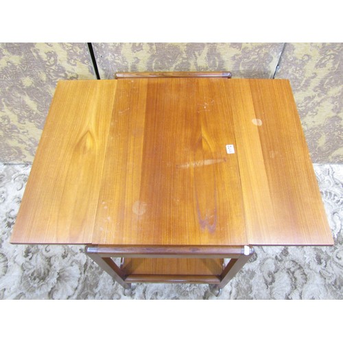 1172 - A mid 20th century teak tea trolley, a nest of occasional tables and a retro leather swivel chair (3... 