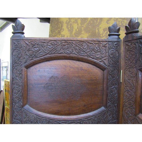 1208A - A Kashmir three fold hardwood room divider of full height with panelled frame within repeating flora... 