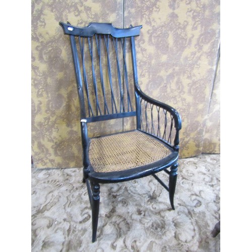 1432 - A 19th century  high backed ebonised elbow chair with cane panelled seat and interlaced back