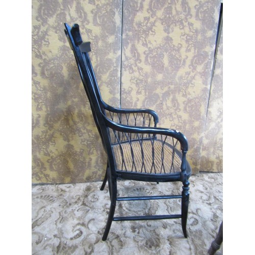 1432 - A 19th century  high backed ebonised elbow chair with cane panelled seat and interlaced back