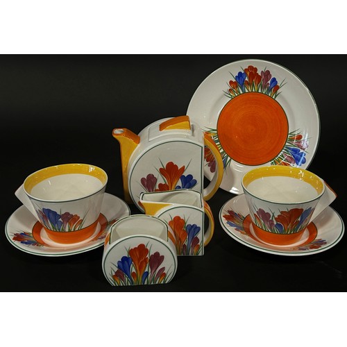 7 - A Clarice Cliff style crocus pattern group of tea ware, teapot, sugar and milk, two cups and saucers... 