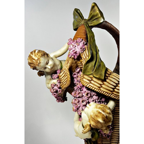 9 - Substantial pottery basket shaped vase accompanied by two cherubs (af) 46cm high