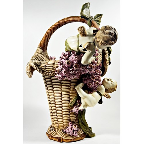 9 - Substantial pottery basket shaped vase accompanied by two cherubs (af) 46cm high