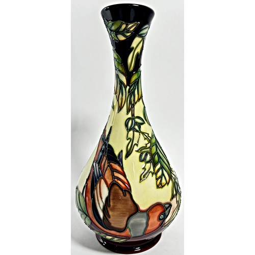 15 - A Moorcroft bottle shaped vase, decorated with birds perched on leafy branches, 23cm high