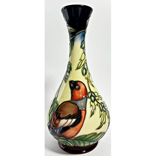 15 - A Moorcroft bottle shaped vase, decorated with birds perched on leafy branches, 23cm high