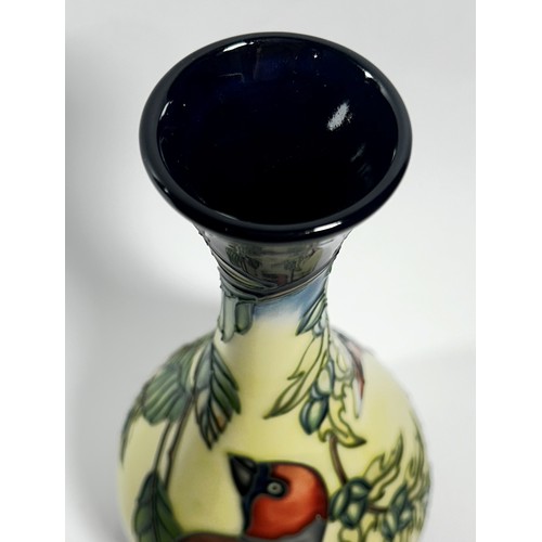 15 - A Moorcroft bottle shaped vase, decorated with birds perched on leafy branches, 23cm high