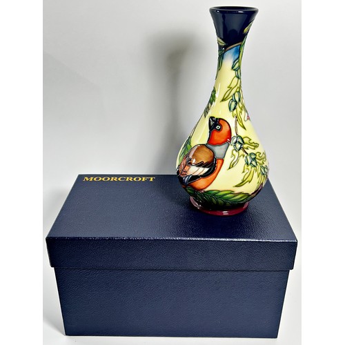 15 - A Moorcroft bottle shaped vase, decorated with birds perched on leafy branches, 23cm high