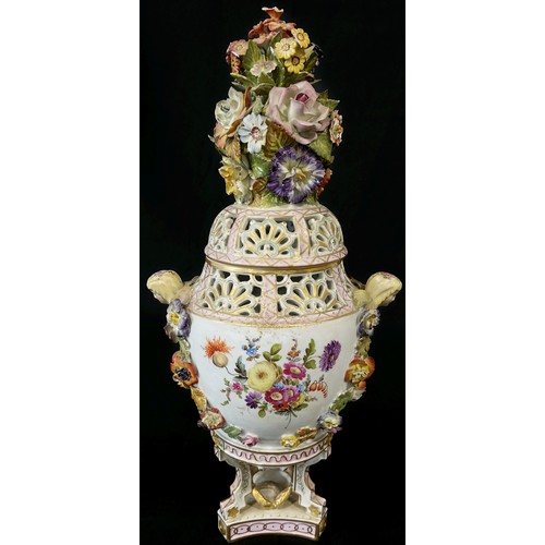 31 - A 19th century Dresden porcelain urn raised on three shaped supports with hand-painted panels showin... 