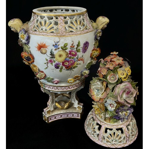 31 - A 19th century Dresden porcelain urn raised on three shaped supports with hand-painted panels showin... 