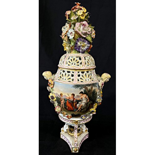 31 - A 19th century Dresden porcelain urn raised on three shaped supports with hand-painted panels showin... 