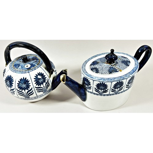 32 - An aesthetic period Marigold pattern blue and white globular teapot and further example in oval form... 