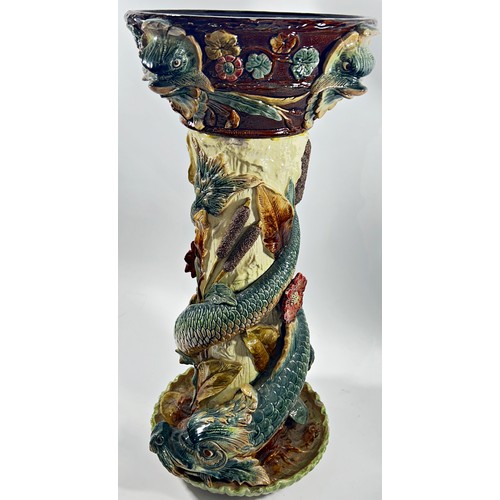 74 - A 19th century majolica jardinere stand, the column entwined by dolphins and bullrushes, 72cm high