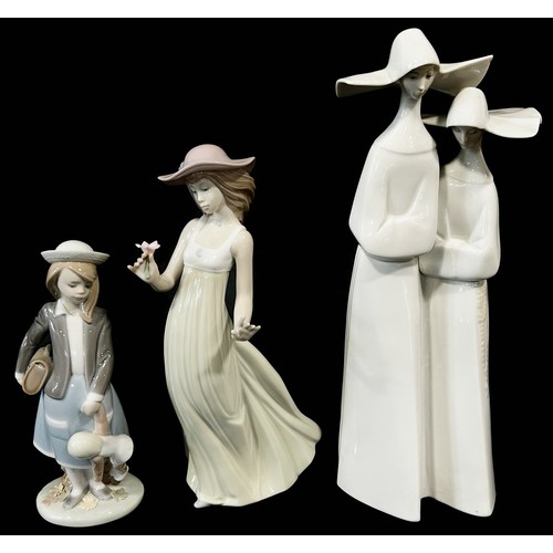 91 - Four Lladro figures and one Nao figure to include Nun, Young Schoolgirl, Puppy in a Boat etc