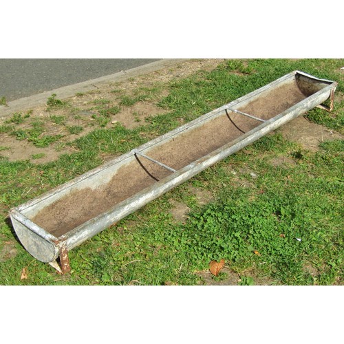 1042 - A weathered rectangular galvanised feeding trough with two simple rung divisions, later drilled and ... 