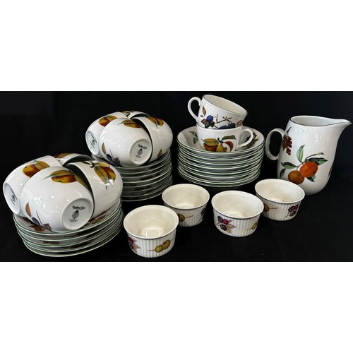 40 - A collection of Royal Worcester Evesham Vale pattern table ware, comprising cups and saucers, gradua... 