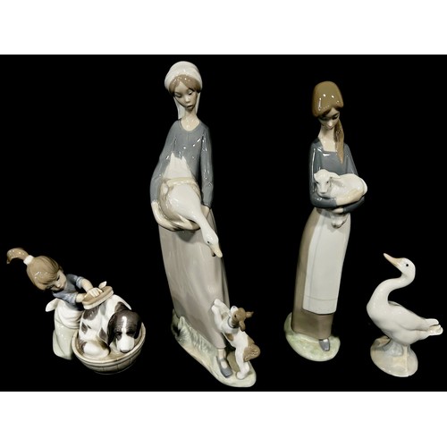 121 - A collection of five Lladro figures, girl with goose, another with lamb, another washing a dog etc