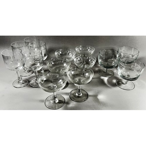 173 - A large quantity of glassware, including seventeen cut glass Champagne flutes, eleven etched glass C... 