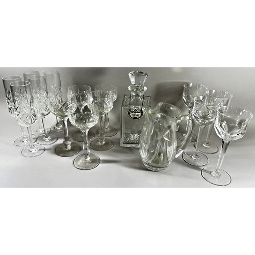 173 - A large quantity of glassware, including seventeen cut glass Champagne flutes, eleven etched glass C... 