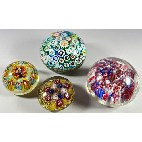 174 - Four millefiori multi-cane scatter glass paperweights of differing sizes, most lightly scratched and... 