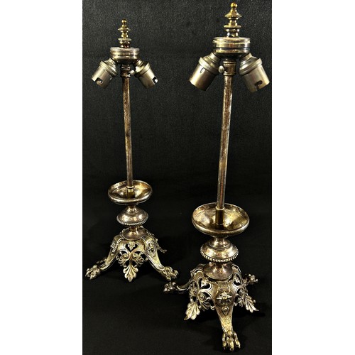 204 - A pair of silver plated adjustable table lamps raised on decorative hairy paw feet.