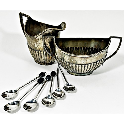 244 - A silver milk jug with a matching sugar bowl with half gadrooned decoration and six coffee spoons, 1... 