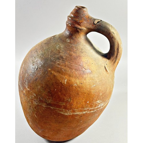 123 - An early terracotta sprinkler flagon, the body of bulbous form with loop handle, the base with pierc... 