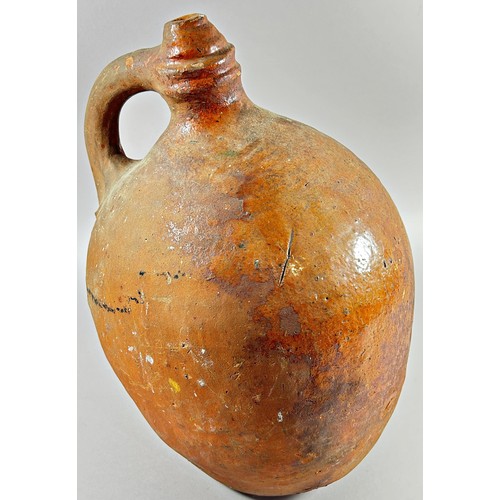 123 - An early terracotta sprinkler flagon, the body of bulbous form with loop handle, the base with pierc... 