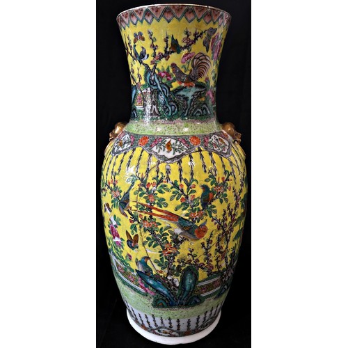 63 - A Chinese 19th century Famille rose vase with a decorative flower and bird design on a yellow ground... 