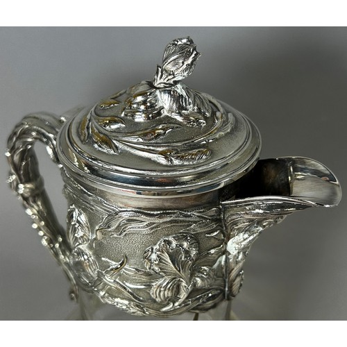 208 - A good quality early 20th century silver plated claret jug with engraved flowers to collar and spout... 