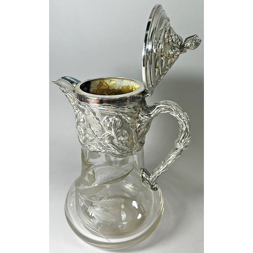 208 - A good quality early 20th century silver plated claret jug with engraved flowers to collar and spout... 