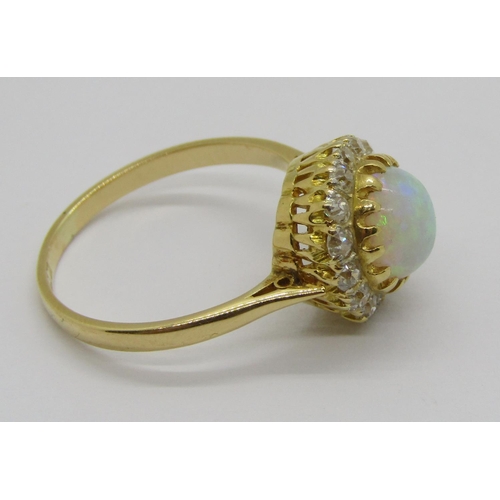 335 - Early 20th century 18ct cabochon opal and diamond cluster ring, the deep cabochon opal 3mm H x 6.5 d... 