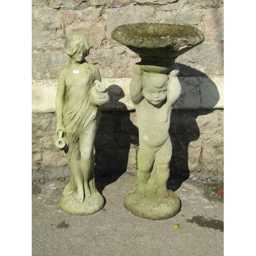 1012 - A weathered two sectional cast composition stone bird bath, the pedestal in the form of a standing c... 