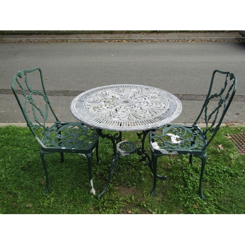 1016 - A weathered green painted three piece cast aluminium garden terrace set with scrolling and trailing ... 