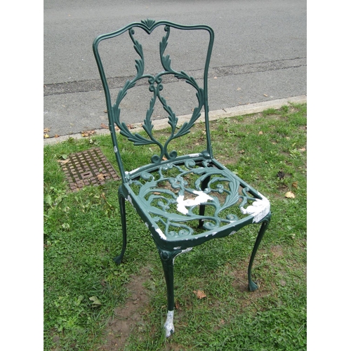 1016 - A weathered green painted three piece cast aluminium garden terrace set with scrolling and trailing ... 