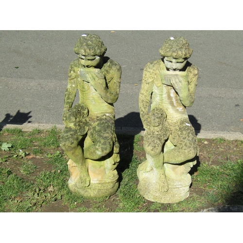 1018 - A matched pair of weathered cast composition stone pan garden ornaments seated with rabbits, 85 cm h... 