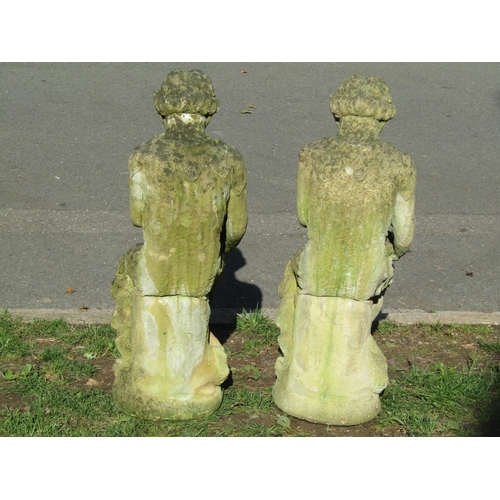 1018 - A matched pair of weathered cast composition stone pan garden ornaments seated with rabbits, 85 cm h... 