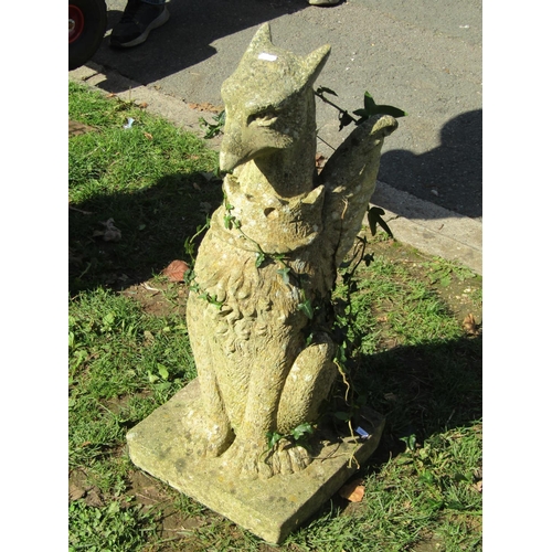 1019 - A weathered cast composition stone garden/pier ornament in the form of a seated dragon, 74 cm high