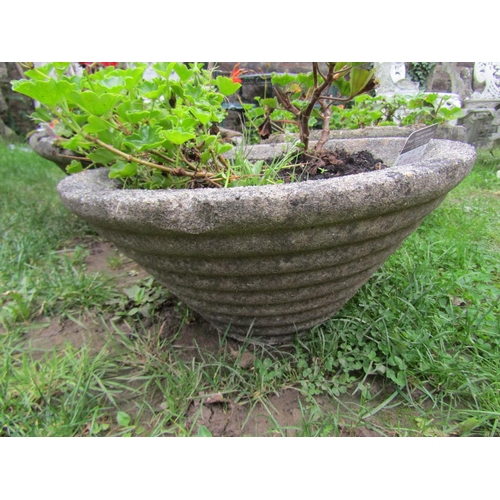 1037 - A pair of weathered cast composition stone squat conical shaped garden planters with ribbed detail, ... 