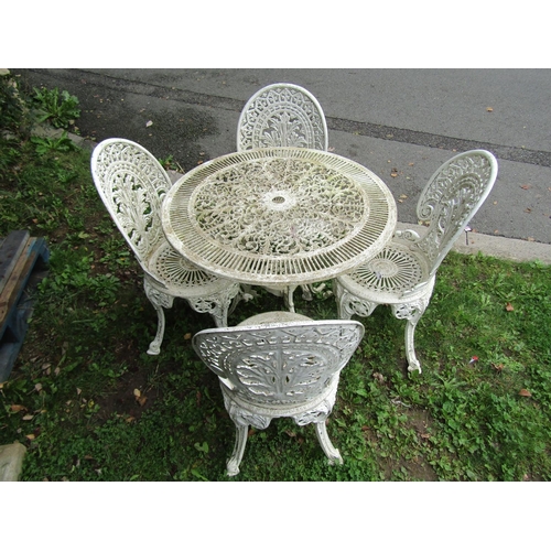 1044 - A weathered cream painted cast aluminium garden terrace table of circular form with decorative pierc... 