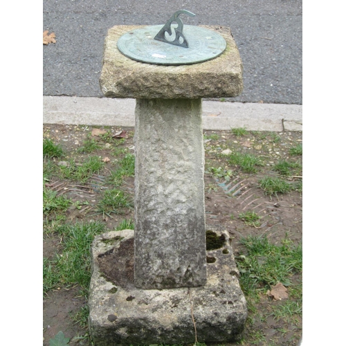 1046 - A weathered garden sun dial with pierced gnomon set and raised on a three sectional rough hewn base,... 