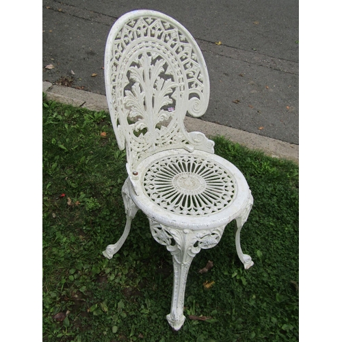 1047 - A weathered cream painted cast alloy garden terrace table of circular form with decorative pierced r... 