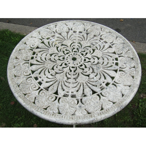 1047 - A weathered cream painted cast alloy garden terrace table of circular form with decorative pierced r... 