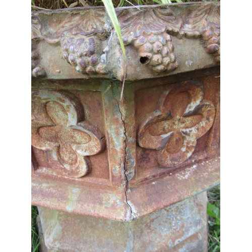 1058 - A large weathered cast iron font/ planter of octagonal form with gothic tracery detail (planted), 68... 