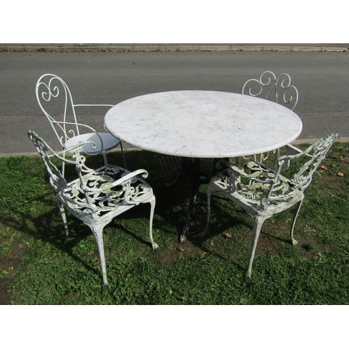 1059 - A weathered garden table the overhanging circular marble top 120 cm diameter raised on a swept cast ... 