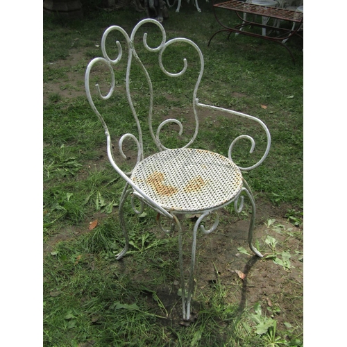 1059 - A weathered garden table the overhanging circular marble top 120 cm diameter raised on a swept cast ... 